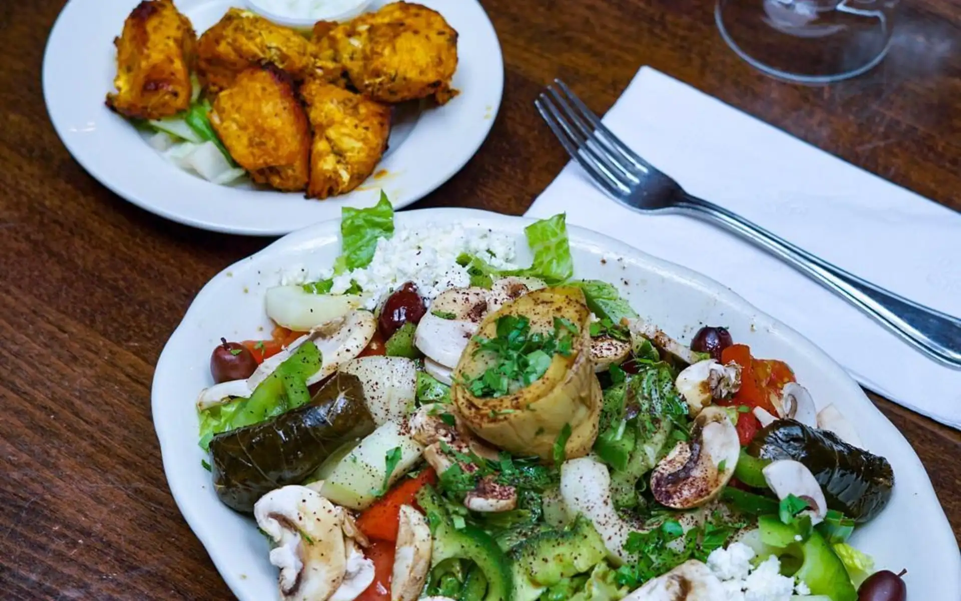 A colorful Mediterranean salad and shared plates